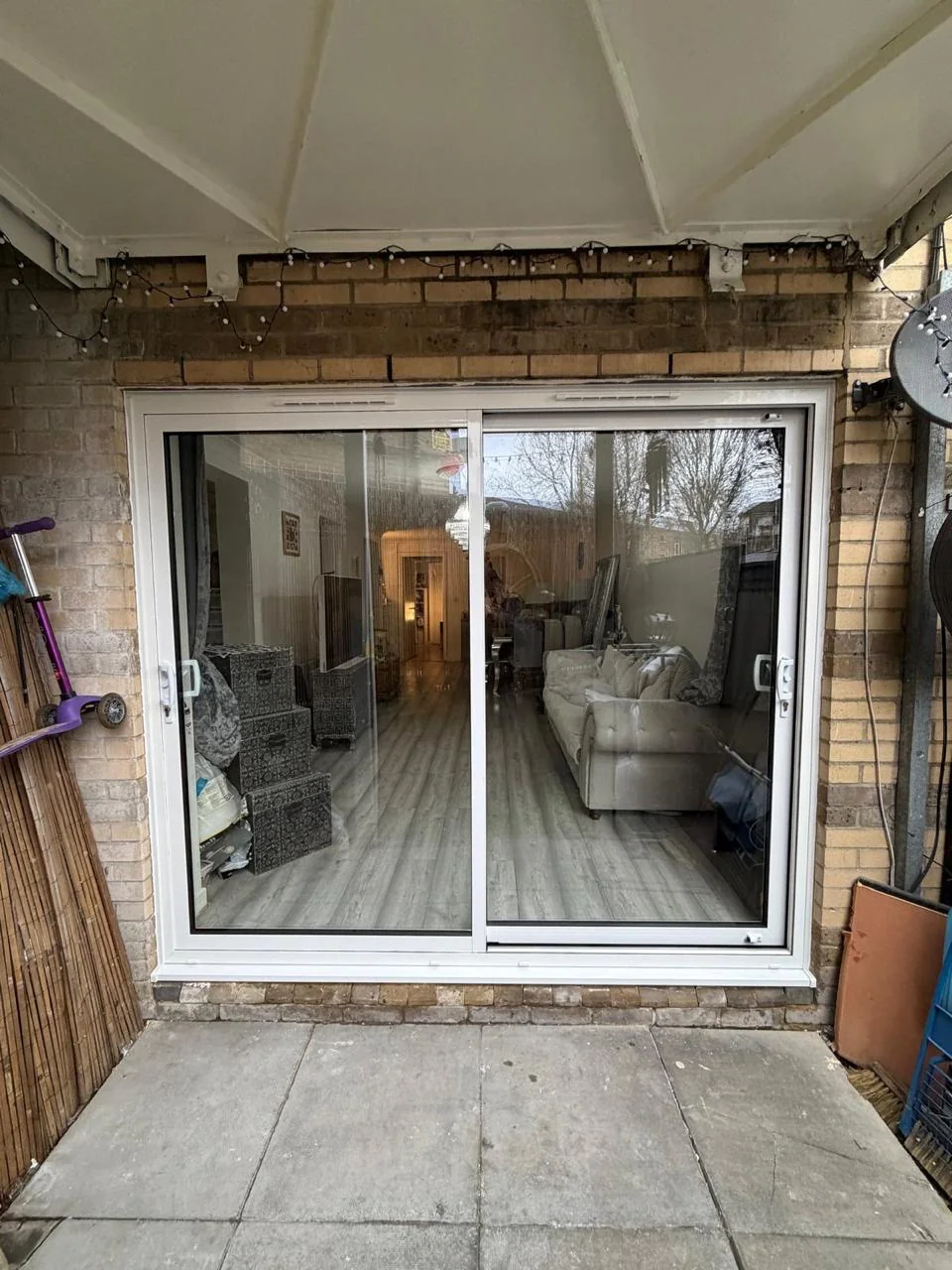 White sliding patio doors fitted in a brick opening