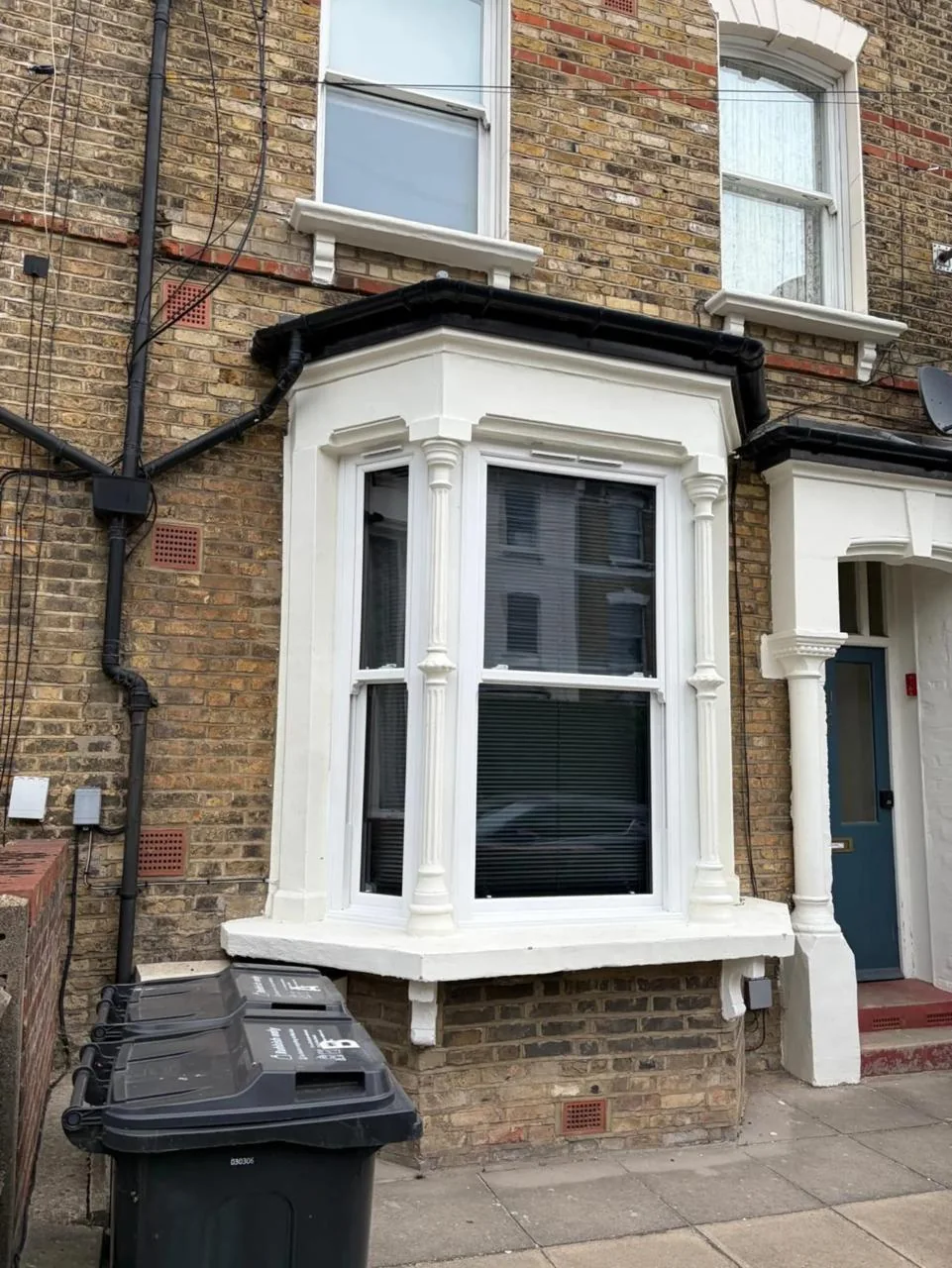 White sash windows fitted in a traditional bay