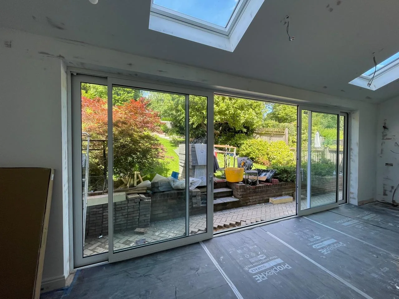 Two rooflights above a glazed extension during interior finishing
