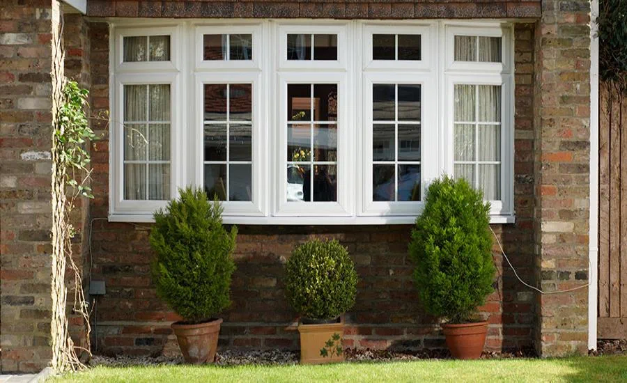 White uPVC bay window on a traditional brick home