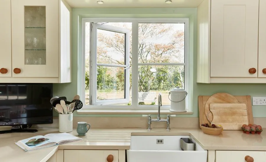 White uPVC casement window opened above a kitchen sink