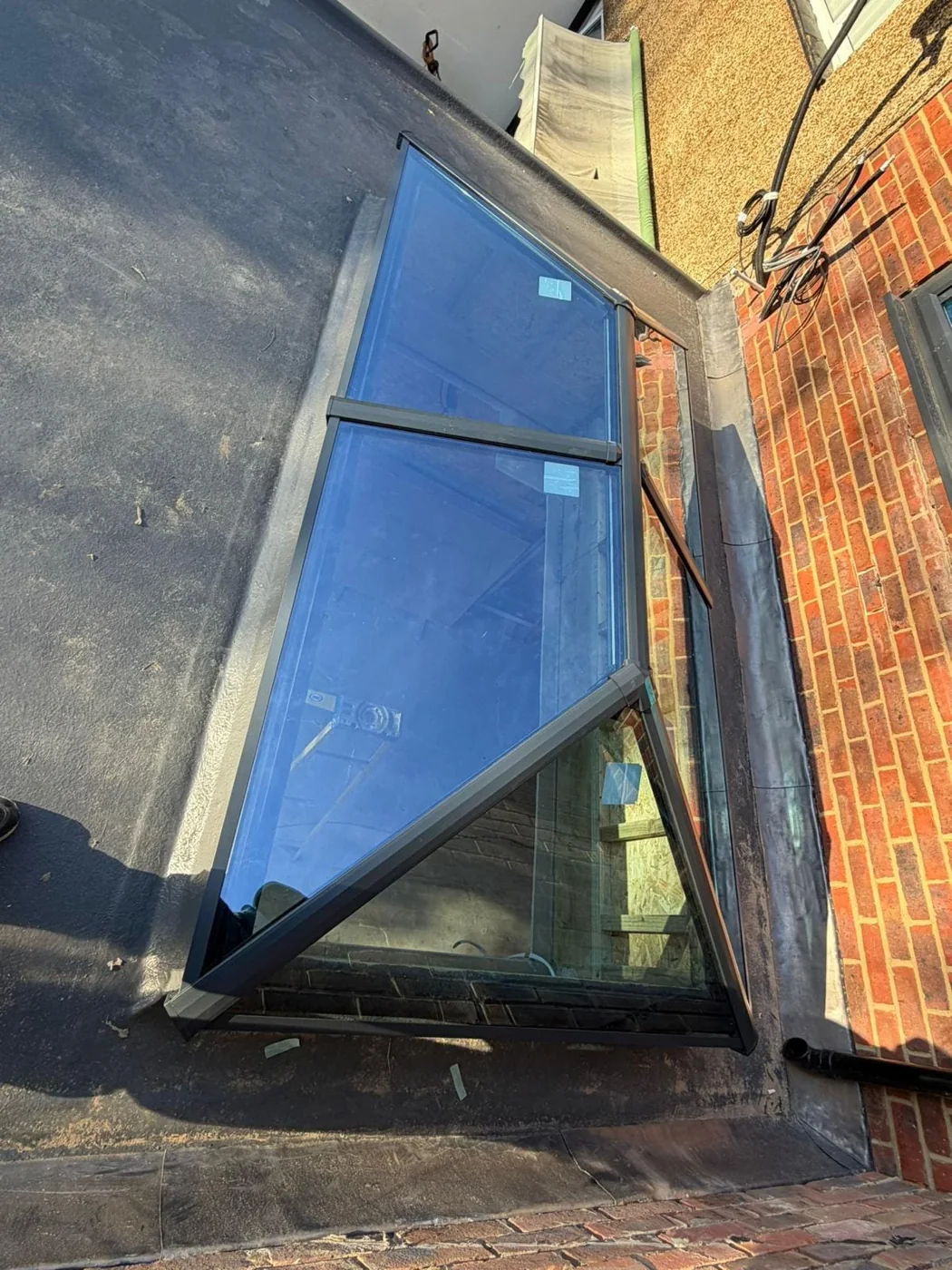 Grey aluminium roof lantern newly installed on a flat roof