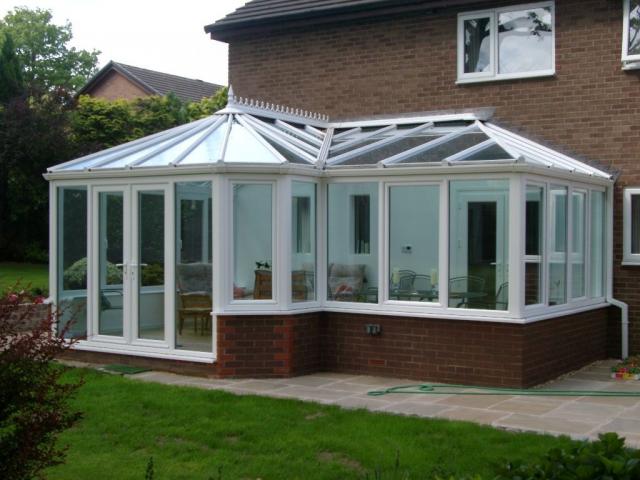 P-shaped white conservatory with garden view