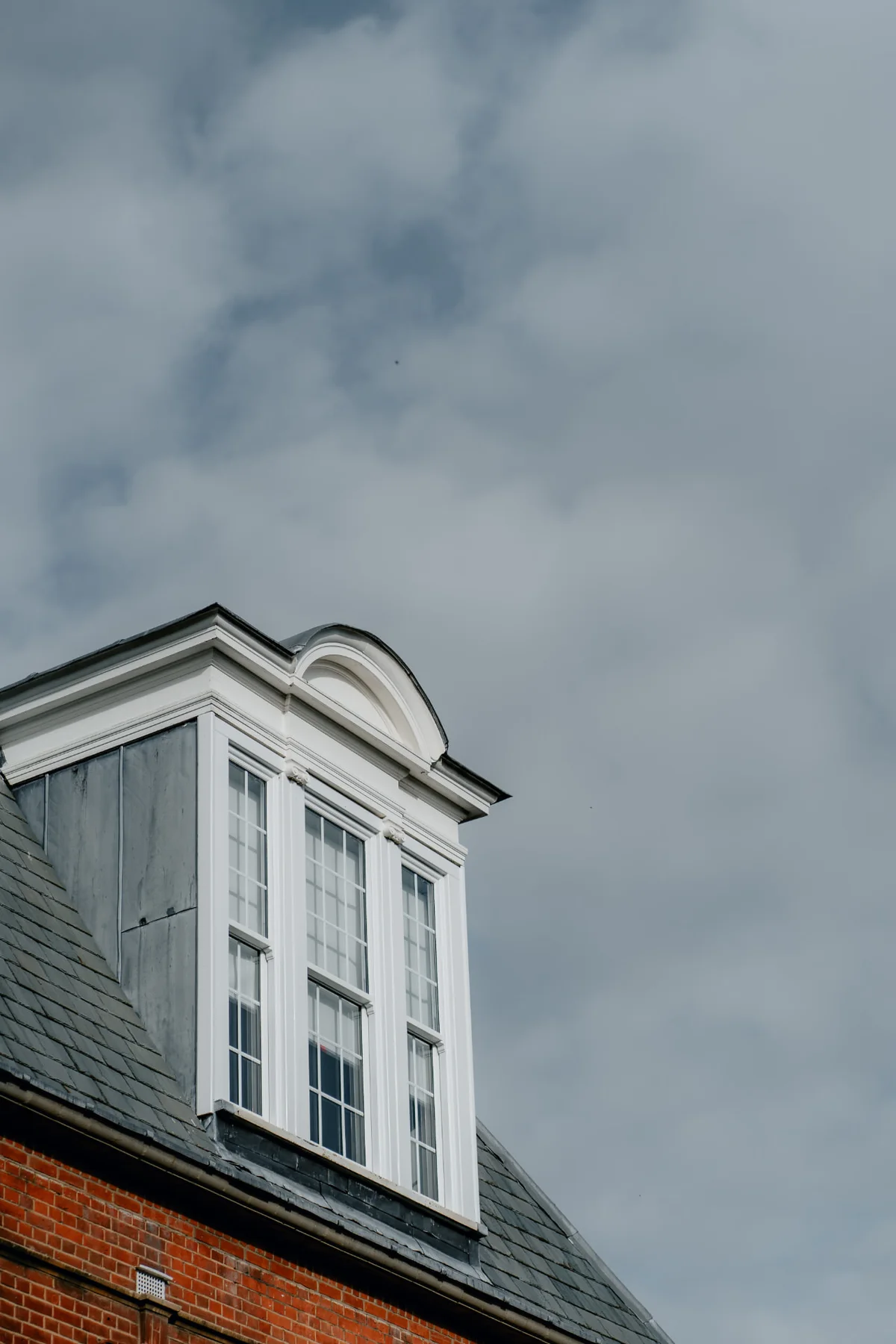 Tall white sash windows in a traditional dormer