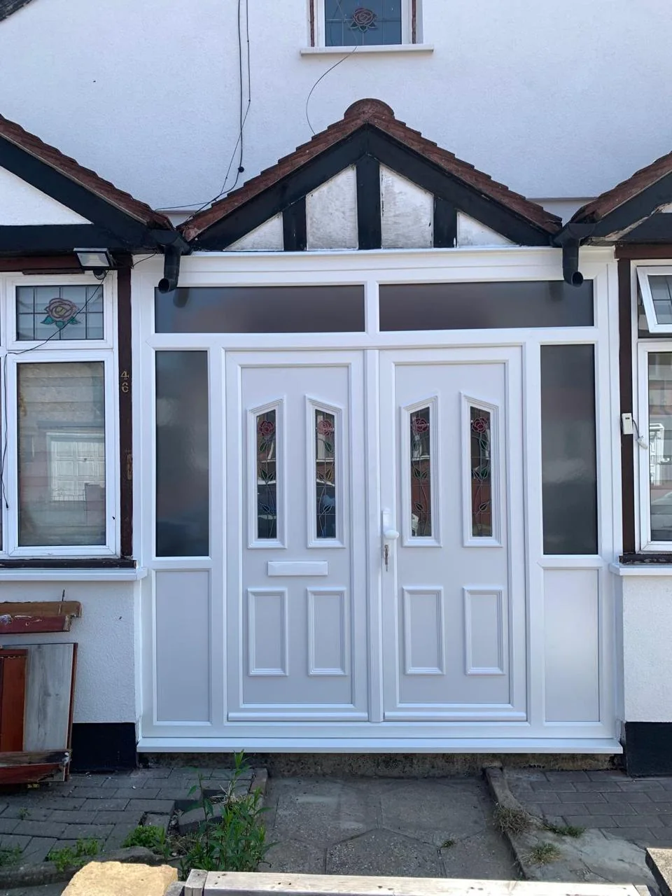 Composite entrance door fitted within a glazed porch enclosure