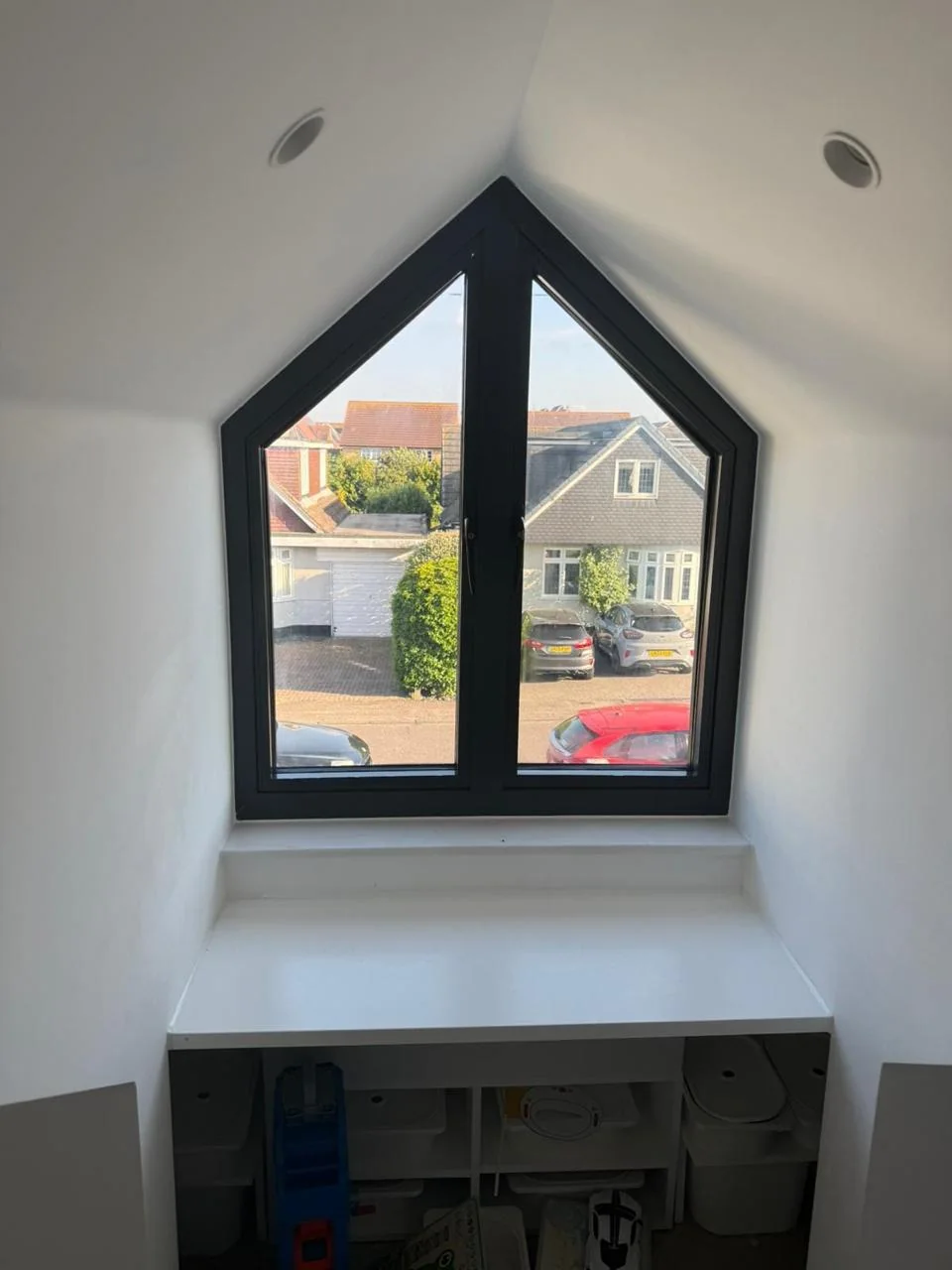 Bespoke dark framed angled window in a loft interior