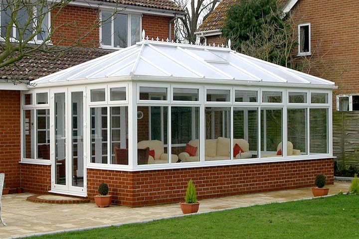 Large white Edwardian conservatory on a brick British home