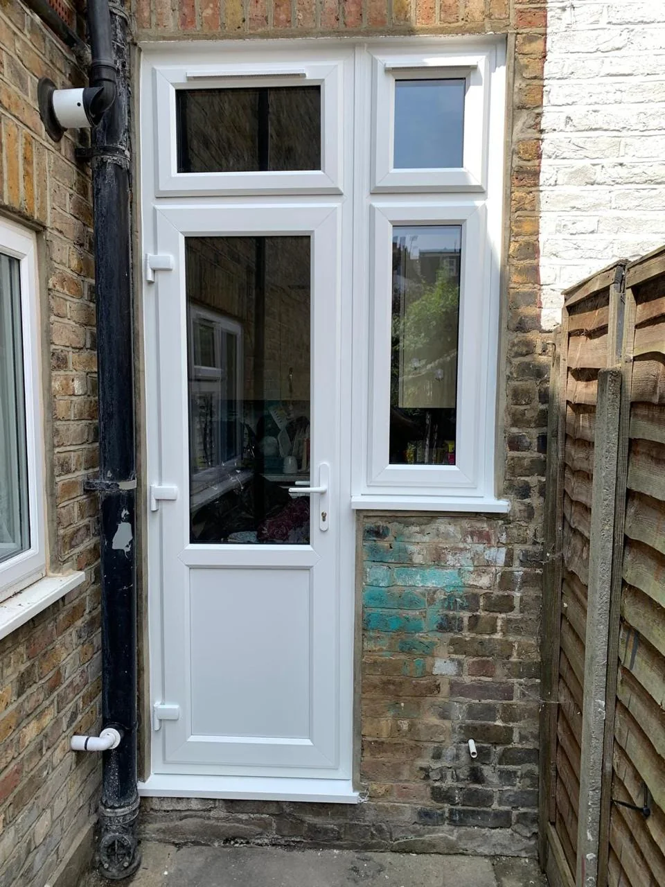 White uPVC glazed back door with adjoining window