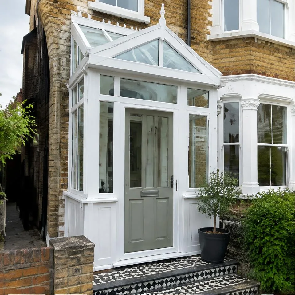 Bespoke porches installed at a traditional brick home in natural daylight