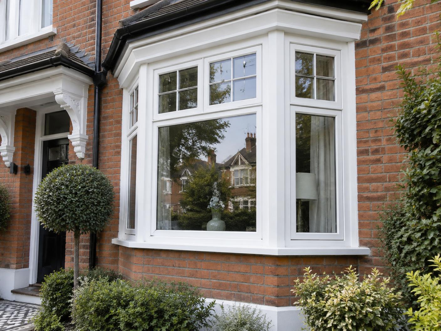 White uPVC bay window installed on a traditional London brick home