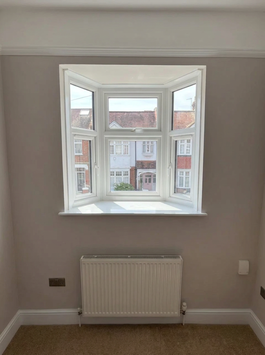 Clean white three-sided bay window in a finished residential room