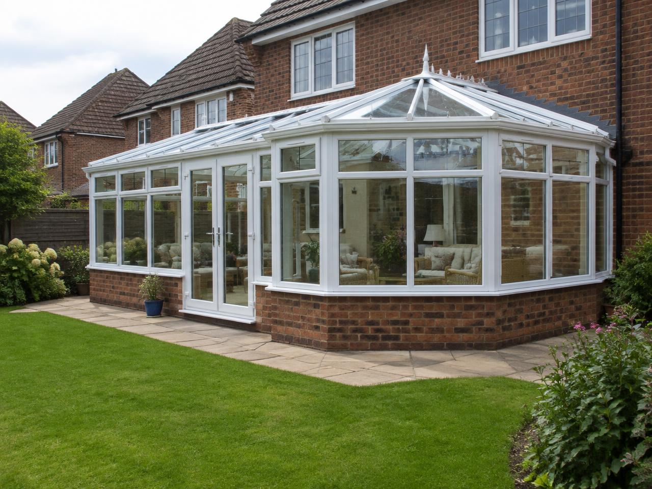 Large white uPVC P-shaped conservatory combining lean-to and bay-fronted sections